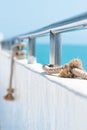 Ship railing with rope and blue sea Royalty Free Stock Photo