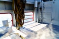 Ship railing on sunny deck with ropes Royalty Free Stock Photo