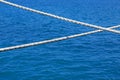 Ship rope against blue water sea texture background Royalty Free Stock Photo