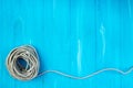 Ship rope knot on blue wooden texture background. Top view Royalty Free Stock Photo