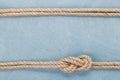 Ship rope knot on wooden texture background Royalty Free Stock Photo