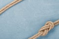 Ship rope knot on wooden texture background Royalty Free Stock Photo