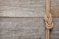 Ship rope knot on wooden texture background Royalty Free Stock Photo