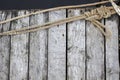 Ship rope with marine knot on the old wooden pier on the background of dark vrdy Royalty Free Stock Photo