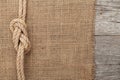 Ship rope on wood and burlap texture background Royalty Free Stock Photo