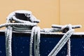 Ship ropes covered with snow in winter