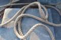 Ship ropes pile tied to knot on cement flooring background at port closeup. Royalty Free Stock Photo