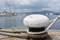 Ship ropes tied to an old bollard - detail, Varna harbor, Bulgaria Royalty Free Stock Photo