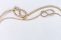 Ship ropes on white wooden background. Double stopper