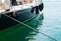 Ship\'s bow and aquamarine water in the port of Syracuse, Sicily. Boat and sea, detail. Sailing vessel drops anchor