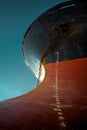 Ship`s bow with red waterline against the blue sky. World shipping freight concept Royalty Free Stock Photo