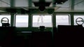 Silhouette of the ship`s bridge with sea and sky infront of the windows.