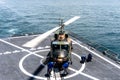 Ship`s crew release chalks and chains that ties down the Bell 212 helicopter of royal Thai navy on the flight deck of HTMS.