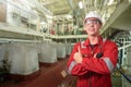 Ship`s mechanic near marine diesel generators on a merchant ship in the engine room Royalty Free Stock Photo