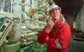 Ship`s mechanic near marine diesel generators on a merchant ship in the engine room Royalty Free Stock Photo