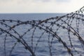 Ship\'s side fortified with razor wire. Anti piracy protection. HRA, High Risk Areas. close up view.