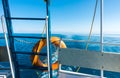 Ship`s stern, lifeline. Footprint on the water from the boat. Blue water and mountains on the horizon. Issyk-Kul, Kyrgyzstan Royalty Free Stock Photo