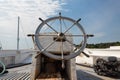 Ship`s wheel helm of an old sailing vessel, boat deck with rope rigging Royalty Free Stock Photo