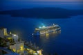 Ship sailing away from Santorini at night Royalty Free Stock Photo