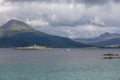 Ship sailing on the blue water of the norwegian fjords in polar day, midnight sun Royalty Free Stock Photo