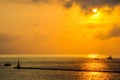 Ship sailing in the sea at sunset