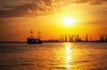 Ship sailing on the sea to the shore at sunrise. Royalty Free Stock Photo