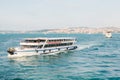 The ship sails along the blue water of the Bosphorus against the backdrop of a beautiful view of the European part of
