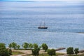 Beautiful seascape. Lone ship floats at the blue sea.