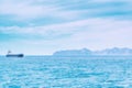 A ship in the sea and mountains on the horizon near the city of Cartagena, Spain Royalty Free Stock Photo