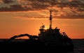 Ship on sea at sunset.