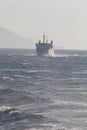 Ship in the sea. Waves and mist.