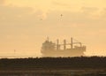 Ship Carrying Windmill Blades in the Shipping Channel at Sunrise