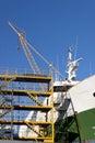 Ship in the shipyard for maintenance and repairs with scaffolds and crane Royalty Free Stock Photo