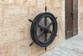 Ship steering wheel hanging on the wall as decoration on the street in Bethlehem in Palestine