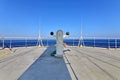 Ship structures, masts, antennas, funnel, ship wheelhouse against the blue sky and clouds.