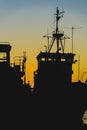 Ship at sunset in dock, loading, unloading. Silhouette, port landscape. Bright sunset Royalty Free Stock Photo