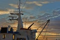 Ship, sunset and harbor at sea to travel with closeup, clouds and transportation for vacation sailing. Ship, dock and Royalty Free Stock Photo