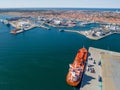 The ship-tanker with oil is unloaded in the fuel trucks in port.