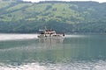 Ship with tourists on a green lake