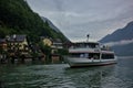 A ship with tourists on the picturesque Lake Hallstatter near the village of Hallstatt