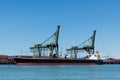 Ship is unloading the iron ore Royalty Free Stock Photo