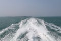 Ship wake on the ocean.aves from the back of a speed boat over the water`s surface in sea. Waves behind a boat on a clear blue se Royalty Free Stock Photo