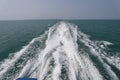 Ship wake on the ocean.aves from the back of a speed boat over the water`s surface in sea. Waves behind a boat on a clear blue sea Royalty Free Stock Photo