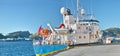 Ship, water and harbor at sea to coast guard with landscape, blue sky and transportation for emergency sailing. Vessel Royalty Free Stock Photo
