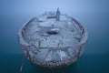 Ship wreck in fog and calm water