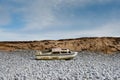 Ship wreck of an old boat washed up on a rocky beach