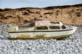 Ship wreck of an old boat washed up on a rocky beach