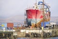 Ship wreck vessel and rescue lift crane at port dock for repair of capsized boat Royalty Free Stock Photo