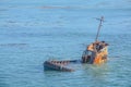 Ship wrecked fishing vessel on the rocks of Estero Bluffs State Park in San Luis Obispo County, California