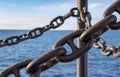 Ship& x27;s black chains against the blue sea and blue sky in summer